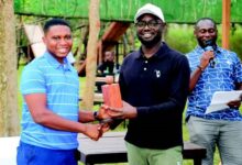 •Mr Samuel Afari Dartey (middle) presenting a prize to Christopher Mbi