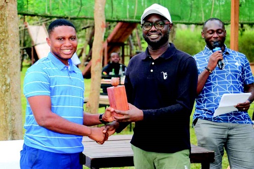 •Mr Samuel Afari Dartey (middle) presenting a prize to Christopher Mbi