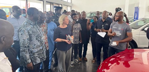 • Mr Kyerematen (left) and others inspecting some of the vehicles on display at the showroom