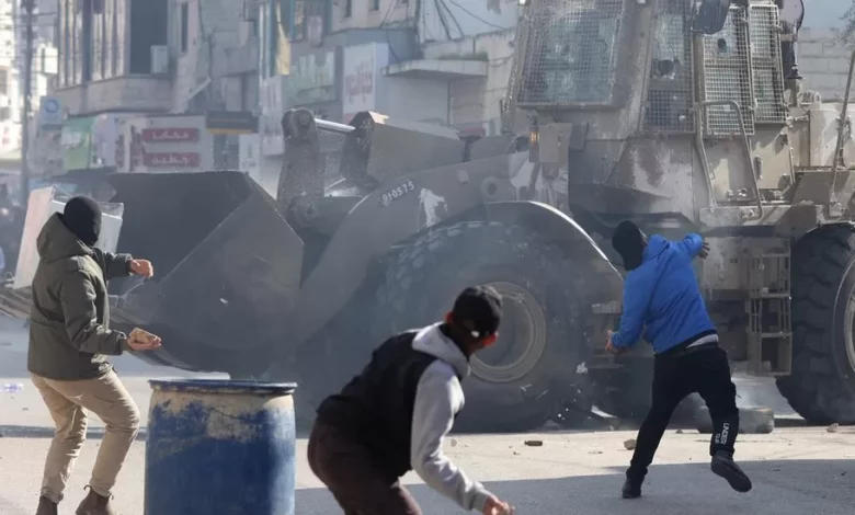 • Palestinians throw stones amid clashes with Israeli troops during a raid in Jenin