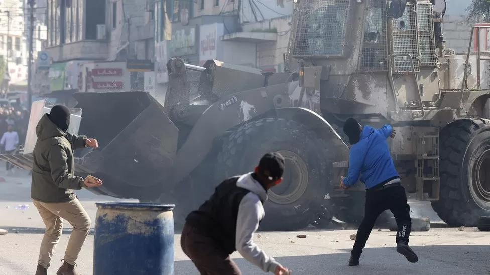 • Palestinians throw stones amid clashes with Israeli troops during a raid in Jenin