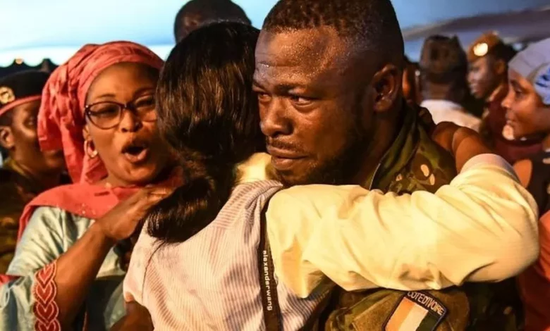 • One of the freed Ivorian soldiers being welcomed by relatives