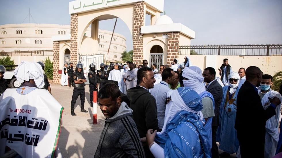 • People gather outside the court house during the opening of the corruption trial