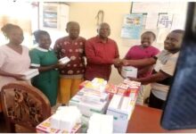 • Mr Justice Marfo, head of the centre (right) receiving the items from Mr Sersah-Johnson while staff of the centre and others look on
