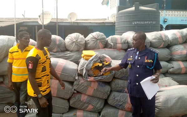 • Charles Agbeke, officer in charge of Dabala checkpoint (left) and Mr Dari (right) opening one of the sacks