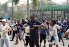 • Mr Asante (middle) with some staff of the bank engaged in aerobics after the walk