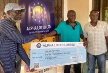 • Mr Nukamewor (left) presenting the cheque to Silas Tetteh at a brief ceremony