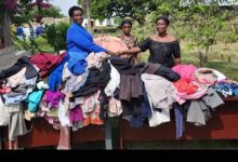 • Lady Reverend Nshiraba presenting the clothing to some beneficiaries