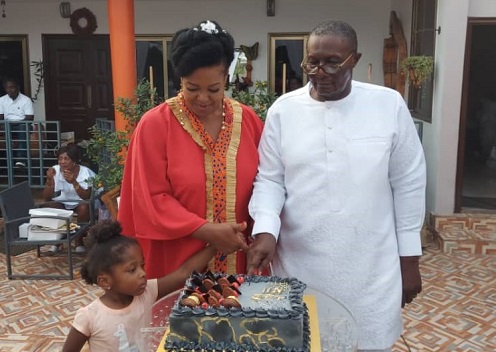 • Nii Ashitey (right) with his wife cutting the cake