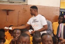 • Mr Quaye giving out some chocolate to the pupils
