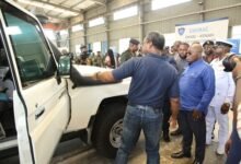 Mr Kenneth Akibate (left) introducing one of the assembled amoured vehicles to President Akufo-Addo