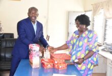 • Mr Oppong Nkrumah (left), presenting some chocolates to Mrs Georgina Naa - Maku Quaittoo, Acting Editor, The Spectator Photo: Seth Osabukle