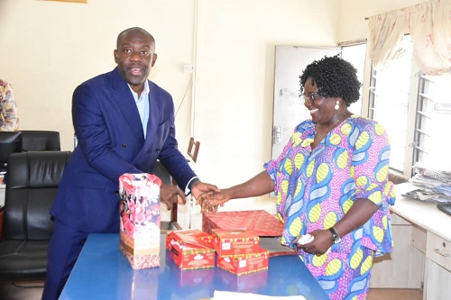 • Mr Oppong Nkrumah (left), presenting some chocolates to Mrs Georgina Naa - Maku Quaittoo, Acting Editor, The Spectator Photo: Seth Osabukle