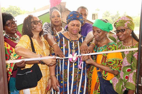 • Inset, Ms Gzifa (right) assisted by other dignitaries to cut the tape for the opening of the facility