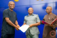 • Mr Ussif (left) presenting an appointment letter to Dr Boadi-Mensah