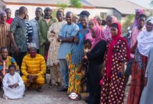 • Inset: Members of the community after the inauguration of the borehole