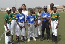 • Ms Teragaki and Mr Elletey with some of the female baseball players Photo: Victor A. Buxton