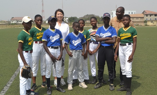 • Ms Teragaki and Mr Elletey with some of the female baseball players Photo: Victor A. Buxton