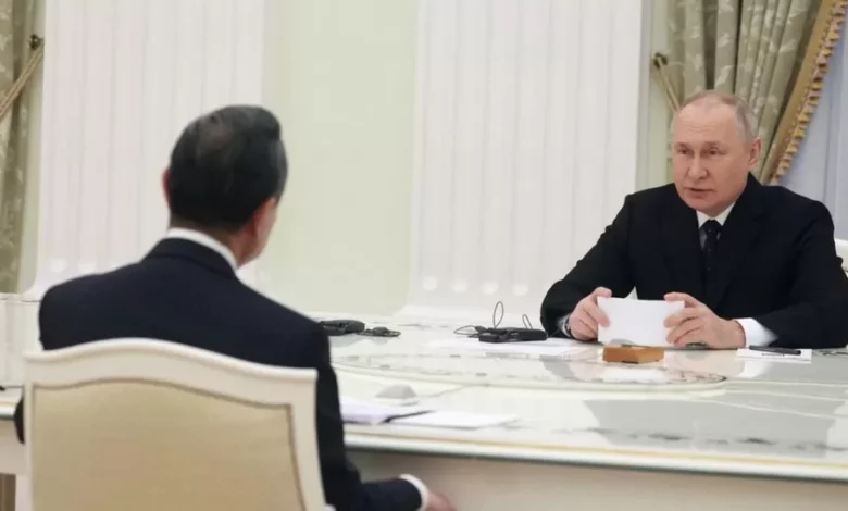 • President Putin (right) in a chat with Mr Yi