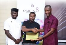 Joseph Agbeko (middle) in a handshake with an official of Ace Power Promotions after signing the partnership