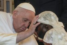 • Pope Francis praying for a war victim