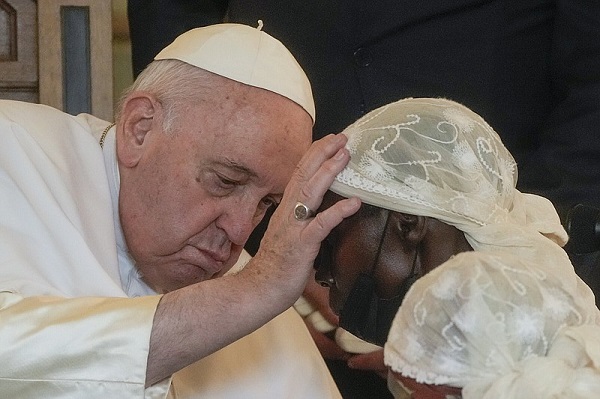 • Pope Francis praying for a war victim