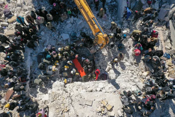 • An aerial picture shows rescuers searching the rubble of buildings for casualties and survivors in the village of Salqin