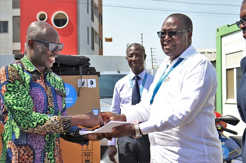 • Dr Kasolo (right) presenting the keys to Dr Ofosu