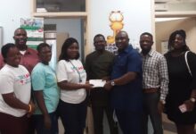 • Mr Addai (third from right) presenting the cash donation to Dr Schandorf