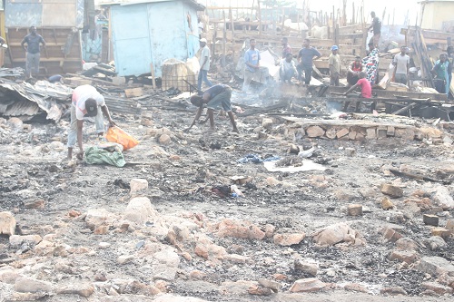 • Scrap dealers salvaging for metals after the fire Photo: Anita Nyarko-Yirenkyi