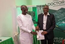 • Dr Anthony Adofo Ofosu, the author of the book, presenting a copy during the launch