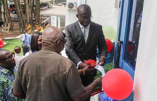 • Inset: William Owuraku Aidoo (in suit) being assisted by other dignitaries to cut the tape to open the facility