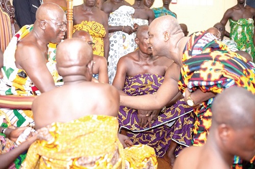 • Mr Addai-Nimo (right) in a handshake with the Asantehene