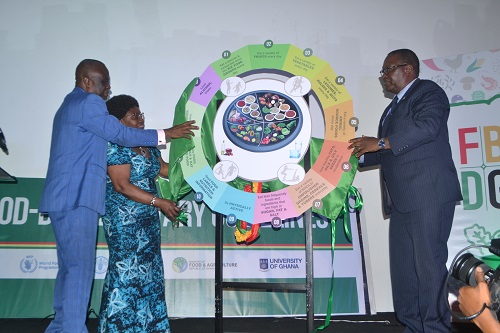 • Mr Yaw Frimpong Addo (left) being assited by Prof. Anna Lartey (second from left) and Dr Francis Kasolo to officially unveil and launch the guidelines Photo: Victor A. Buxton