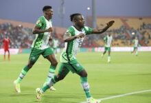 Moses Simon (right) joined by a colleague to celebrate Nigeria's own goal