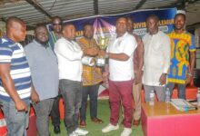 Mr. Attoh (right) handing over the ultimate trophy to Mr. Boateng