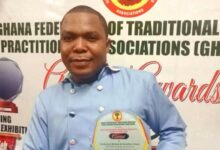 • Dr Tetteh displaying his plaque after receiving the award