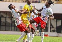 • A Tamale City attacker sandwiched by players of Hearts in a midfield battle