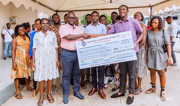 Mr Asenso-Boakye (left) presenting the cheque to some beneficiaries