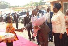 Pastor (Dr) W.F Kumuyi receiving a flower bouquet during his arrival for the global crusade in Accra. Photo. Ebo Gorman