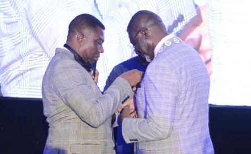 • Rev. Prof. Adams (left) decorating Mr Bempong with the chain of office