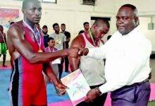 • Mr Amefu (right) presenting a certificate to one of the winners