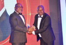 • Mr Stanley Martey (left) receiving his award from Dr William Oppong Photo: Vincent Dzatse