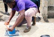 Mr Aheto helping to install the pump on the borehole