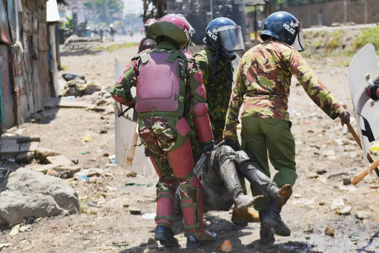 Riot police detain a supporter of Kenya's opposition leader Raila Odinga