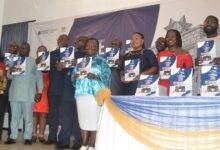 Prof. Amin Alhassan assisted by other dignitaries during the launch of the report Photo Victor A. Buxton