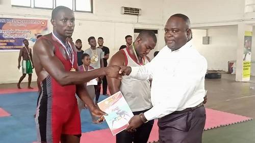 Mr Amefu (right) presenting a certificate to one of the winners
