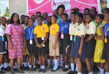 Pupils in a a group picture with Founder of the LLN.