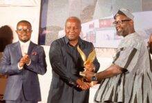 Mr Provencal (right) receiving the award from former President Mahama