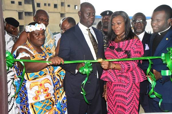 Justice,KwasiAnin-Yeboah (middle) being assisted by Nii Dr Ayi-Bonte II (left) and Mrs Elizabeth Sackey to cut the tape to open the facility Photo Seth Osabukle